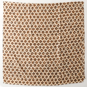 Detail of elegant pashmina scarf featuring golden floral patterns and fringe edges