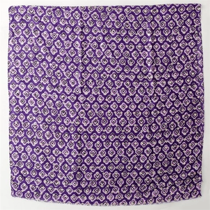 Detail of purple printed floral scarf with soft cotton-linen texture and frayed edges