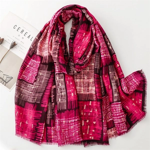 Detailed flat lay of fuchsia geometric scarf with fringe edges and cotton linen texture