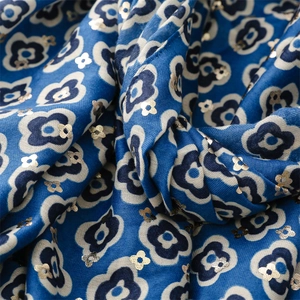 Detail of blue floral cotton linen scarf with gold foil camellia pattern accents