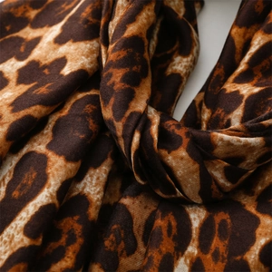 Close-up of leopard print cotton linen scarf with rich brown and beige textures