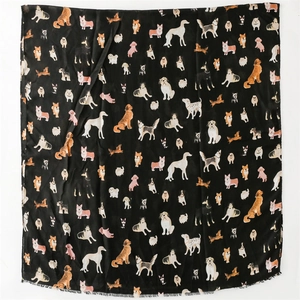 Detail of soft black shawl with cute cartoon dog prints and subtle fringed edges