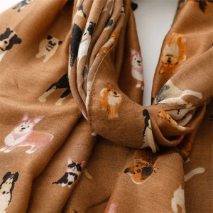 Detailed view of soft brown cotton scarf featuring cute cartoon dog breed prints