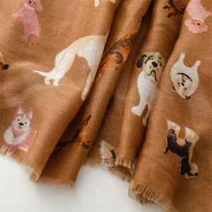 Detail of soft brown cotton-linen scarf with cute cartoon dog prints and frayed edges