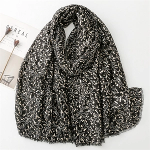 Women's black cotton linen scarf with gold leaf foil print and frayed fringe edges