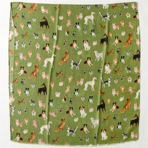 Flat lay of cotton-linen scarf with cute dog patterns and frayed fringe edges
