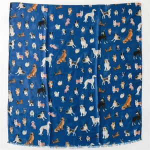 Close-up of cotton-linen feel scarf with colorful dog patterns and short fringe detail
