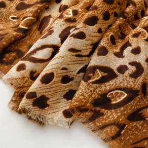 Detail of leopard print scarf with gold foil accents and soft frayed edge texture