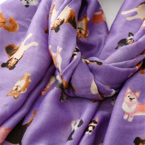 Close-up of soft purple cotton linen scarf with cute cartoon dog prints and texture