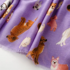 Detail of purple cotton blend scarf with cute cartoon dog illustrations and frayed edges