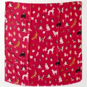 Detailed view of dark red scarf with cute cartoon dog patterns and frayed edges