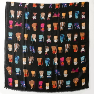 Detail of soft scarf with colorful cartoon cat patterns and fine fringe edges