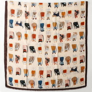 Detailed view of square scarf with cartoon cat prints and fine fringe trim edges