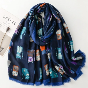 Detail view of navy cotton-linen scarf with colorful cartoon cat print and fringed edges