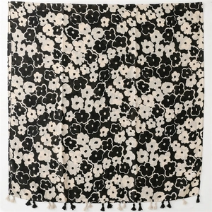 Detail of artistic black flower print on linen feel scarf with bicolor fringe trim