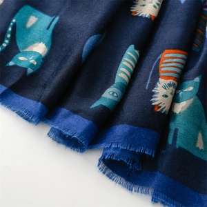 Detail of navy cotton-linen scarf featuring colorful cartoon cat prints and fringe edges
