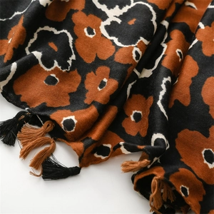 Close-up of retro floral cotton-linen scarf featuring fringe and abstract flower print