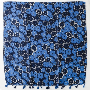Detailed view of blue floral pattern and matching tassels on soft linen-feel scarf