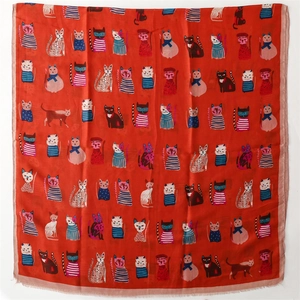 Detail of soft cotton-linen scarf featuring artistic cartoon cat illustrations on orange fabric