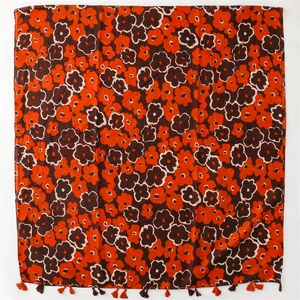 Detailed view of bohemian floral cotton scarf with vivid orange poppy prints and fringe