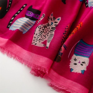 Detail of rose red cotton linen scarf with cartoon cat prints and frayed fringe edges