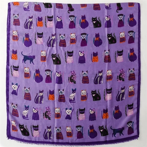 Detail of purple cotton linen scarf with cartoon cat patterns and fine fringe edges