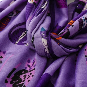 Close-up of purple cotton-linen scarf featuring artistic cartoon cat print and woven texture