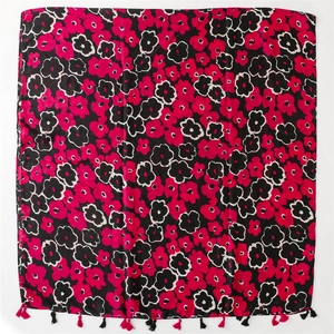 Detail of pink floral print on black cotton linen scarf with soft fringe tassels