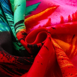 Detailed close-up of peacock feather printed fabric with vibrant colors and twill texture