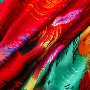Macro detail of colorful peacock feather print on soft cotton linen feel shawl with fringe