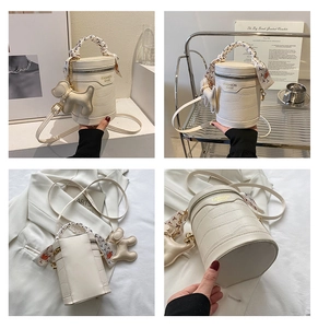 Detail view of cream bucket bag with crocodile pattern and silk scarf handle decoration