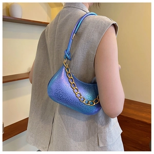 Close-up of iridescent hobo bag with gradient blue-purple finish and gold chain detail