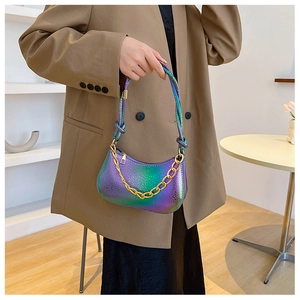 Detail of iridescent purple and green gradient underarm bag with chunky gold chain