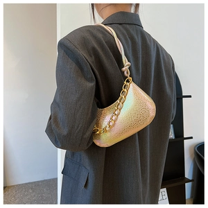 Detail of metallic gradient small shoulder bag with thick gold chain and smooth zipper