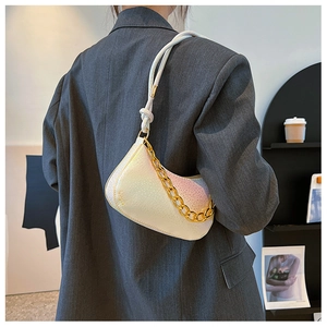 Iridescent white crossbody bag with animal texture and bold gold chain detail
