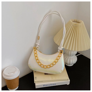 Detail of pearlescent white gradient baguette bag with gold chain and knot handle