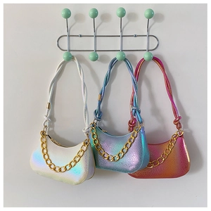 Close-up of holographic crescent underarm bags with thick gold chains and twisted straps