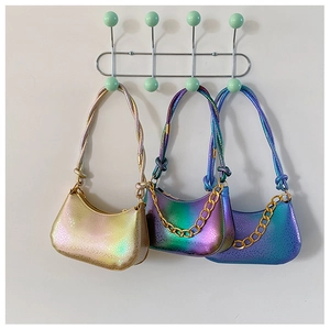 Close-up of metallic snake-print handbag collection with golden chunky chain details