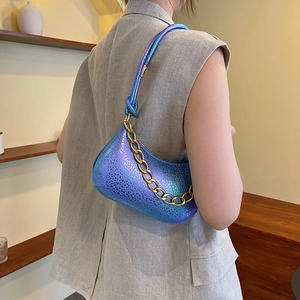 Fashionable gradient blue-purple crossbody bag with metallic gold chain and scaled texture