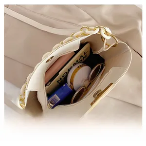 Vue intérieure montrant la grande capacité et le détail de la chaîne du sac beige
