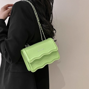 Minimalist neon green crossbody bag with wave flap and braided chain strap for women