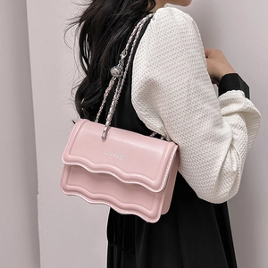 Pink minimalist crossbody bag with wavy flap design and silver chain strap