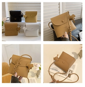 Detail of lychee pattern leather crossbody bag with woven strap and elephant charm