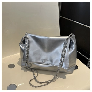 Detail of silver metallic soft leather shoulder bag with chain straps and fashion text