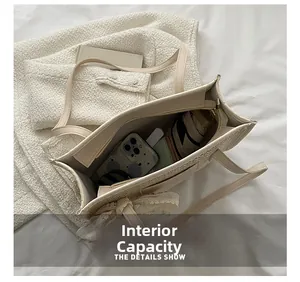 Internal capacity of the woven tote bag showing space for phone, wallet and umbrella