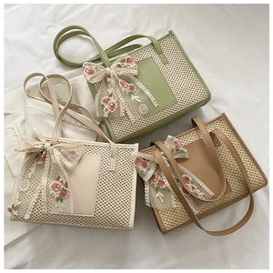 Detail of woven straw tote bags with leather pockets and floral lace bow decorations
