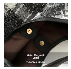 Detail of premium golden magnetic closure on tweed tote bag with leather reinforcement