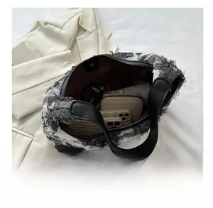 Top view of large plaid tote bag interior showing spacious capacity with personal items