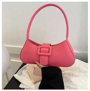 Detail of pink PU leather underarm bag with large square buckle and long handle