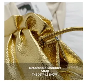 Detail of detachable strap and premium lychee grain gold leather cloud bag texture